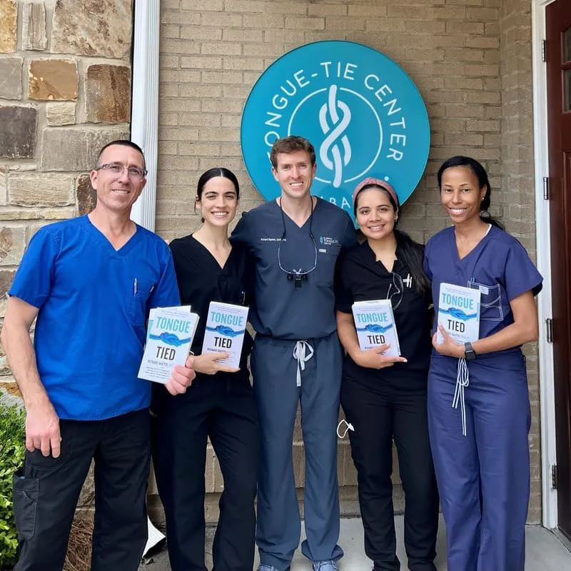 Dr Baxter and participants of the Advanced Live Course holding Dr. Baxter's book.