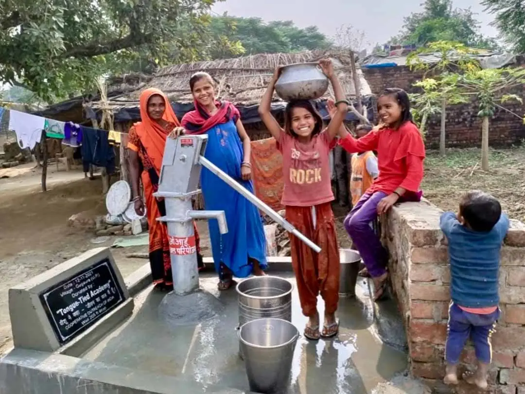 People in Africa drawing water from a well
